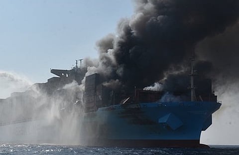The containership Maersk Honam burns in the Arabian Sea after an explosion, as water is sprayed on it by an Indian Coast Guard vessel, March 8, 2018. (Photo: Indian Coast Guard)