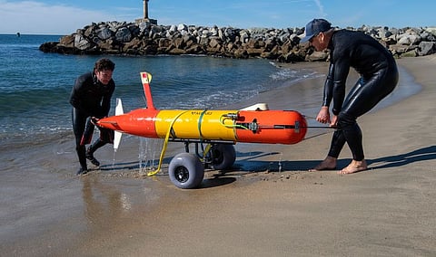 Software Engineer Brian Kieft (left) and Mechanical Engineer Brett Hobson recover a long-range autonomous underwater vehicle (LRAUV) after a successful deployment from the beach adjacent to MBARI’s facilities in Moss Landing, California. (Photo: MBARI/Todd Walsh)
