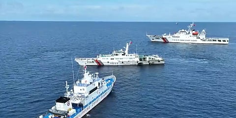 The Philippine Coast Guard patrol vessel BRP Cabra positions itself to prevent two China Coast Guard ships from harassing a civilian boat laden with supplies for Philippine troops on Second Thomas Shoal in the Spratly Islands, August 22, 2023. (Photo: Philippine Coast Guard)