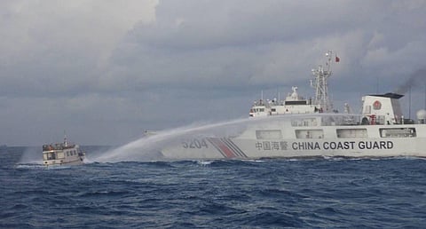 A China Coast Guard patrol ship discharges its water cannon against a small boat attempting to transport supplies to Philippine troops deployed on Second Thomas Shoal, December 10, 2023. (Photo: Philippine Coast Guard)
