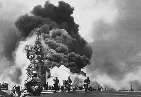 The US Navy aircraft carrier USS Bunker Hill catches fire after being struck by two Japanese kamikaze aircraft off Okinawa on May 11, 1945. (Photo: US Navy)