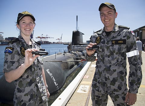 Able Seaman Rhiannon Webb and Seaman Calum Hines show off the Royal Australian Navy submarine HMAS Waller in Fremantle. LSIS Bradley Darvill.