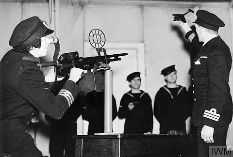 2nd Engineer Miss Victoria Drummond, MBE, practising shooting with the aid of a model enemy aircraft Photo: IWM