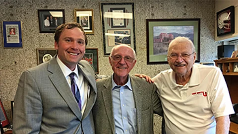 Isaac Flenner, left, poses with Stearns Bank founder Norm Skalicky and Saint John’s University Coach John Gagliardi, under whom Flenner was a tight end from 2000-2003 in Collegeville, Minn.