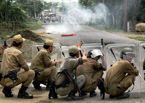 B-27, IMPHAL-040801, AUGUST 04, 2009: Imphal: Police fire teargas shells towards protestors during a general strike called in protest against the death of Sanjit by MPC in a fake encounter, at Khurai in Imphal on Tuesday. PTI Photo