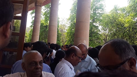 Clerks in a crowded Supreme Court corridor