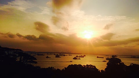 Singapore, sunset, moored vessels, refinery silhouette