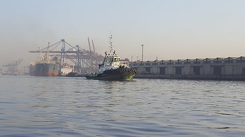 Picture of Karachi port, with tug, and vessel in background