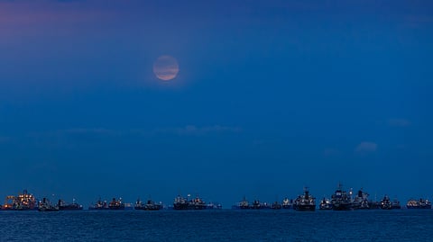 Vessels off Singapore under moon-lit sky