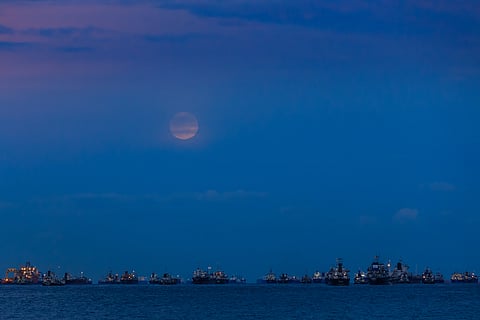 Vessels off Singapore under moon-lit sky