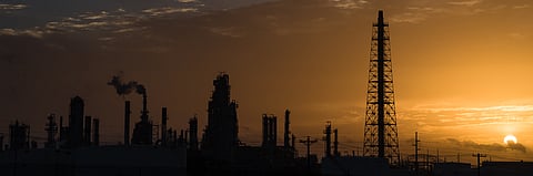 Photo of silhouette of US refinery at sunrise