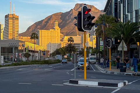 Photo of urban view of Cape Town featuring Table Mountain and city life at sunset
