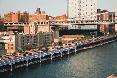 Photo of New York City skyline showing a bustling bridge over the East River
