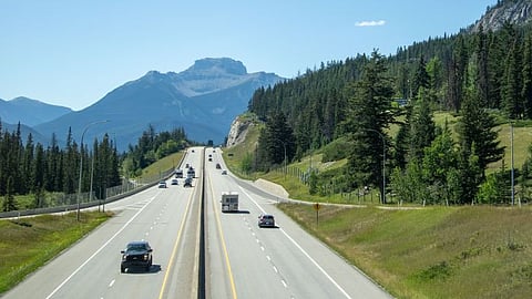 Photo of highway scene in Banff National Park with mountains and greenery