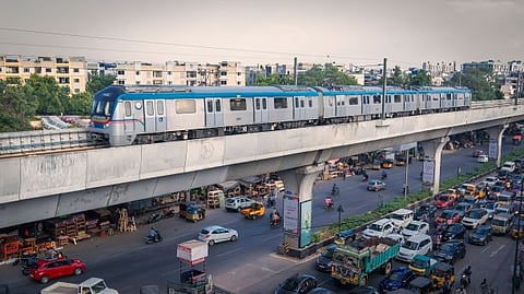 Photo of a metro train above city traffic in bustling Hyderabad, India