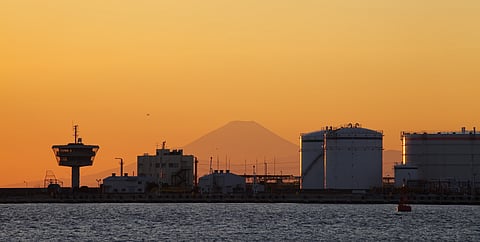 Photo of storage tanks with silhouette of Mt Fuji in the background