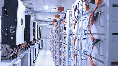 An industrial water treatment plant in Yemen is shown with solar panels, inverter equipment, and battery cabinets representing the commissioned 480kVA/2.49MWh GSL Energy and Deye microgrid.