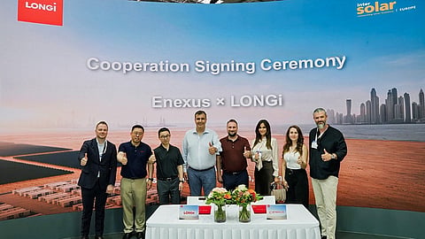 Enexus and LONGi representatives at a signing table before a cooperation signing ceremony backdrop.
