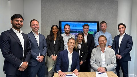 Ten executives from BW ESS and Danske Commodities posing around a table with signed papers.