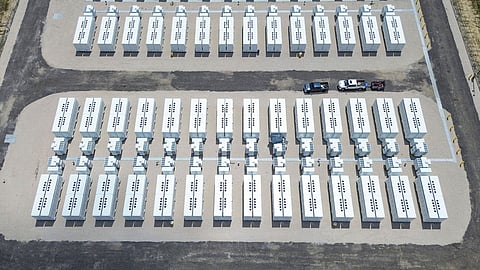 Rows of white battery units on gravel pads at the Bocanova 2 site in Texas.