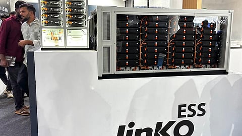 JinkoESS front counter at REI Expo 2026 with an open rack of battery modules.