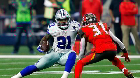 File-This Dec. 23, 2018, file photo shows Dallas Cowboys running back Ezekiel Elliott (21) attempting to evade a tackle by Tampa Bay Buccaneers safety Jordan Whitehead (31) after Elliott caught a pass in the first half time of an NFL football game in Arlington, Texas. Elliott leads NFL with 1,434 yards rushing and 2,001 yards from scrimmage. He is looking for ninth straight game with 100 yards from scrimmage. (AP Photo/Roger Steinman, File)