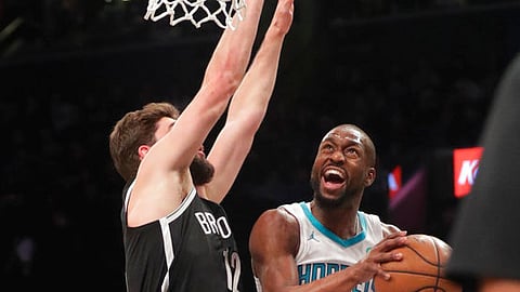 Charlotte Hornets’ Kemba Walker, right, drives past Brooklyn Nets’ Joe Harris during the first half of an NBA basketball game Wednesday, Dec. 26, 2018, in New York. (AP Photo/Frank Franklin II)