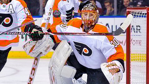 Philadelphia Flyers goaltender Michal Neuvirth (30) keeps his eyes on a flying puck during the second period of an NHL hockey game against the New York Rangers, Sunday, Dec. 23, 2018, in New York. (AP Photo/Howard Simmons)