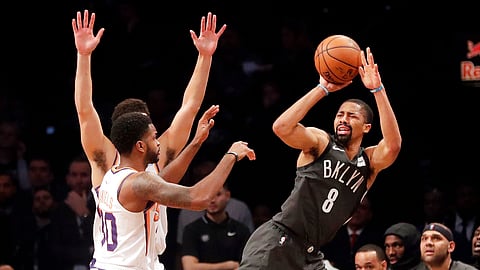 Brooklyn Nets’ Spencer Dinwiddie (8) defends against Phoenix Suns’ Devin Booker (1) during the first half of an NBA basketball game Sunday, Dec. 23, 2018, in New York. (AP Photo/Frank Franklin II)