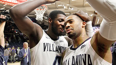 Villanova forward Eric Paschall (4) embraces guard Phil Booth, right, after their team defeated St John’s 76-71 in an NCAA college basketball game, Tuesday, Jan. 8, 2019, in Villanova, Pa. (AP Photo/Laurence Kesterson)