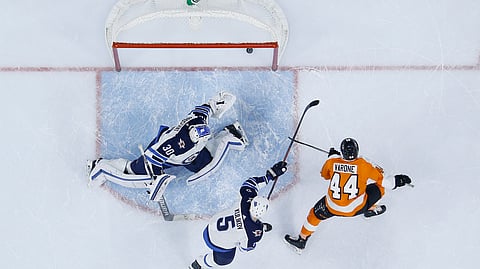 Philadelphia Flyers’ Phil Varone, right, scores a goal against Winnipeg Jets’ Dmitry Kulikov, center, and Laurent Brossoit during the second period of an NHL hockey game, Monday, Jan. 28, 2019, in Philadelphia. (AP Photo/Matt Slocum)
