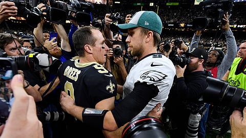 New Orleans Saints quarterback Drew Brees (9) speaks with Philadelphia Eagles quarterback Nick Foles after an NFL divisional playoff football game in New Orleans, Sunday, Jan. 13, 2019. The Saints won 20-14 to advance to the NFC Championship. (AP Photo/Bill Feig)