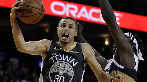 Golden State Warriors’ Stephen Curry shoots against New Orleans Pelicans’ Jrue Holiday during the second half of an NBA basketball game Wednesday, Jan. 16, 2019, in Oakland, Calif. (AP Photo/Ben Margot)
