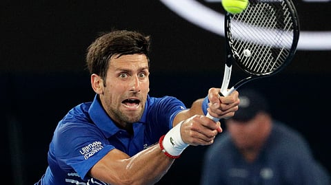 Serbia’s Novak Djokovic makes a backhand return to France’s Jo-Wilfried Tsonga during their second round match at the Australian Open tennis championships in Melbourne, Australia, Thursday, Jan. 17, 2019. (AP Photo/Aaron Favila)