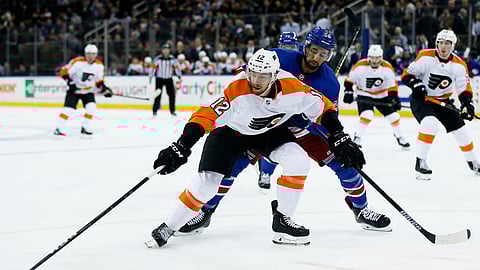 Philadelphia Flyers left wing Michael Raffl (12) battles for the puck with New York Rangers center Boo Nieves (24) in the first period of an NHL hockey game Tuesday, Jan. 29, 2019, in New York. (AP Photo/Adam Hunger)