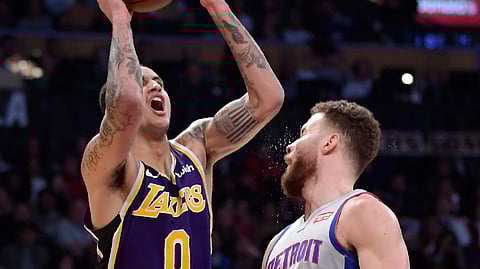 Los Angeles Lakers forward Kyle Kuzma, left, shoots as Detroit Pistons forward Blake Griffin defends during the second half of an NBA basketball game Wednesday, Jan. 9, 2019, in Los Angeles. The Lakers won 113-100. (AP Photo/Mark J. Terrill) 