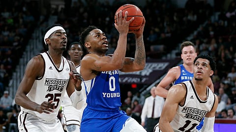Brigham Young guard Jahshire Hardnett (0) leaps past Mississippi State forward Aric Holman (35) and guard Quinndary Weatherspoon (11) during the second half of an NCAA college basketball game in Starkville, Miss., Saturday, Dec. 29, 2018. Mississippi State won 103-81. (AP Photo/Rogelio V. Solis)