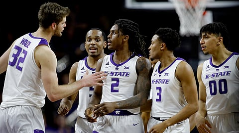 Teammates gather around Kansas State’s Cartier Diarra (2) after he drew a foul during the second half of an NCAA college basketball game against Texas Tech Tuesday, Jan. 22, 2019, in Manhattan, Kan. Kansas State won 58-45. (AP Photo/Charlie Riedel)