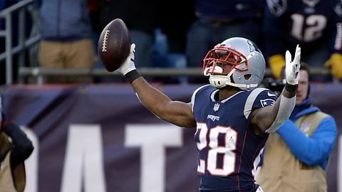 FILE - In this Dec. 23, 2018, file photo, New England Patriots running back James White, right, celebrates his touchdown run as Buffalo Bills safety Micah Hyde (23) sits on the turf during the first half of an NFL football game in Foxborough, Mass. The Patriots play the Kansas City Chiefs on Sunday in the AFC championship game. (AP Photo/Elise Amendola, File)