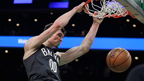 Brooklyn Nets forward Rodions Kurucs (00) slams a dunk during the first quarter of an NBA basketball game against the Boston Celtics in Boston, Monday, Jan. 7, 2019. (AP Photo/Charles Krupa)