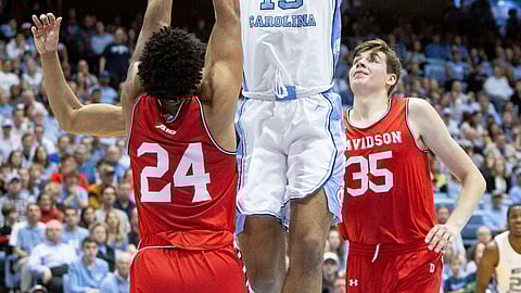 North Carolina’s Garrison Brooks (15) attempts a shot over Davidson’s Carter Collins (24) and Luka Brajkovic (35) during the first half of an NCAA college basketball game in Chapel Hill, N.C., Saturday, Dec. 29, 2018. (AP Photo/Ben McKeown)