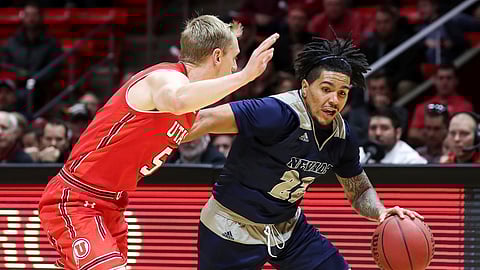 Nevada guard Jazz Johnson (22) dribbles the ball while being guarded by Utah guard Parker Van Dyke (5) during the first half of an NCAA college basketball game, Saturday, Dec. 29, 2018, in Salt Lake City. (AP Photo/Chris Nicoll)