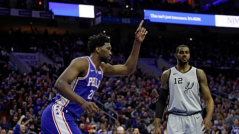 Philadelphia 76ers’ Joel Embiid, left, celebrates after a dunk past San Antonio Spurs’ LaMarcus Aldridge during the first half of an NBA basketball game, Wednesday, Jan. 23, 2019, in Philadelphia. (AP Photo/Matt Slocum)