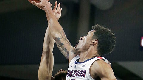 Gonzaga forward Brandon Clarke (15) blocks a shot by Texas-Arlington guard Edric Dennis during the first half of an NCAA college basketball game in Spokane, Wash., Tuesday, Dec. 18, 2018. (AP Photo/Young Kwak)