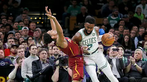 Boston Celtics guard Jaylen Brown (7) drives into Cleveland Cavaliers guard Cameron Payne (3) during the first half of an NBA basketball game, Wednesday, Jan. 23, 2019, in Boston. (AP Photo/Mary Schwalm)