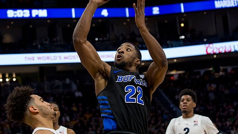 Buffalo guard Dontay Caruthers shoots over Marquette guard Markus Howard, left, during the second half of an NCAA college basketball game Friday, Dec. 21, 2018, in Milwaukee. (AP Photo/Darren Hauck)