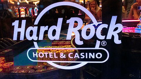 This July 5, 2018 photo shows a roulette dealer behind the glass at a table at the Hard Rock casino in Atlantic City, N.J. On Jan. 26, 2019, Hard Rock began so-called “soft-play” testing of its sports betting equipment and systems and said it hopes to have online and in-person sports betting available before the Feb. 3 Super Bowl. (AP Photo/Wayne Parry)
