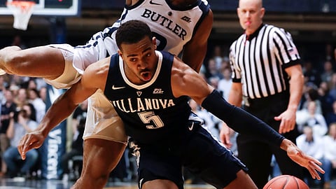 Villanova guard Phil Booth (5) cuts under Butler guard Aaron Thompson (2) in the first half of an NCAA college basketball game in Indianapolis, Tuesday, Jan. 22, 2019. (AP Photo/Michael Conroy)
