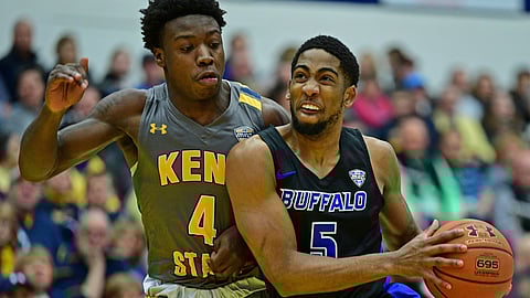 Buffalo guard CJ Massinburg (5) drives against Kent State guard Antonio Williams during the first half of an NCAA college basketball game, Friday, Jan. 25, 2019, in Kent, Ohio. (AP Photo/David Dermer)