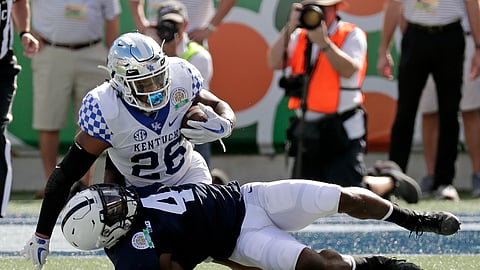 Penn State safety Nick Scott (4) stops Kentucky running back Benny Snell Jr. (26) after a short gain during the first half of the Citrus Bowl NCAA college football game, Tuesday, Jan. 1, 2019, in Orlando, Fla. (AP Photo/John Raoux)